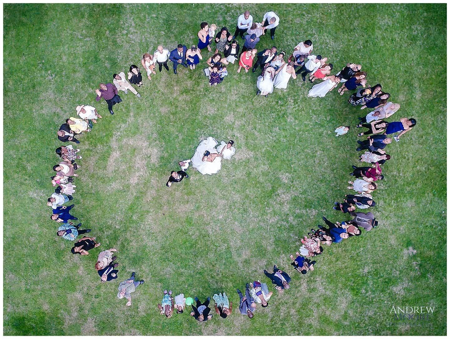 drone aerial photograph of wedding people in circle couple in middle 