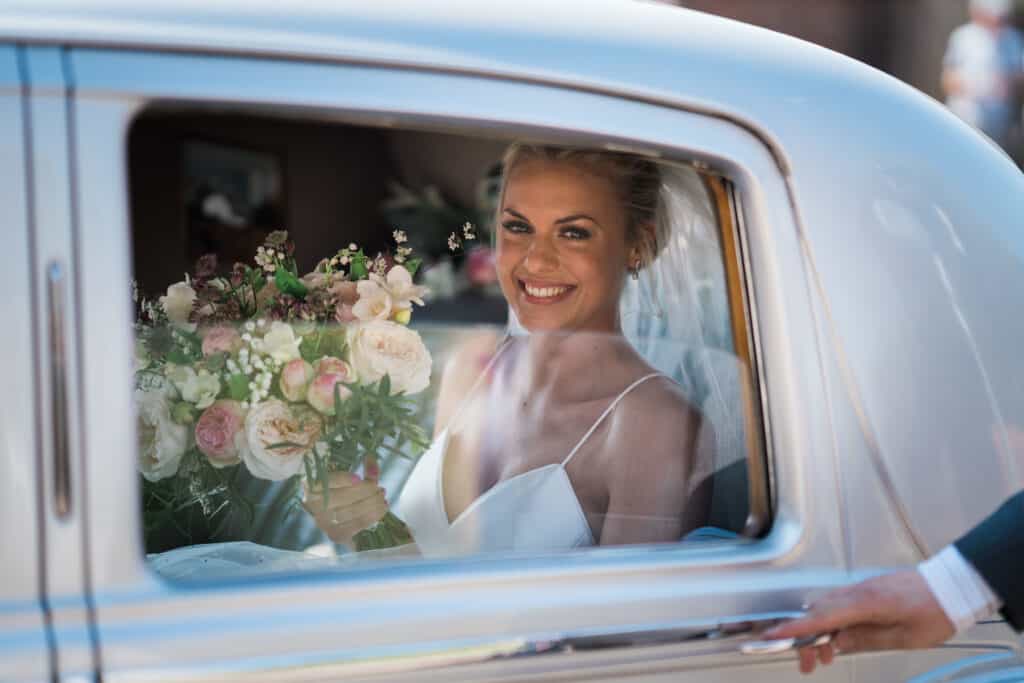Bride in wedding car