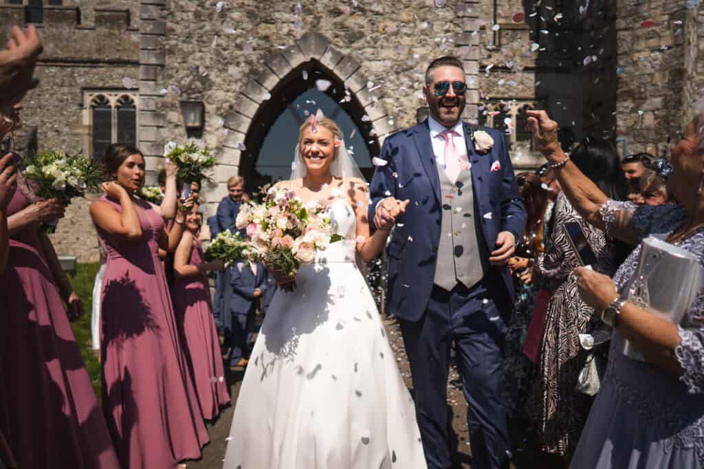 Confetti thrown at bride and groom coming out of the church