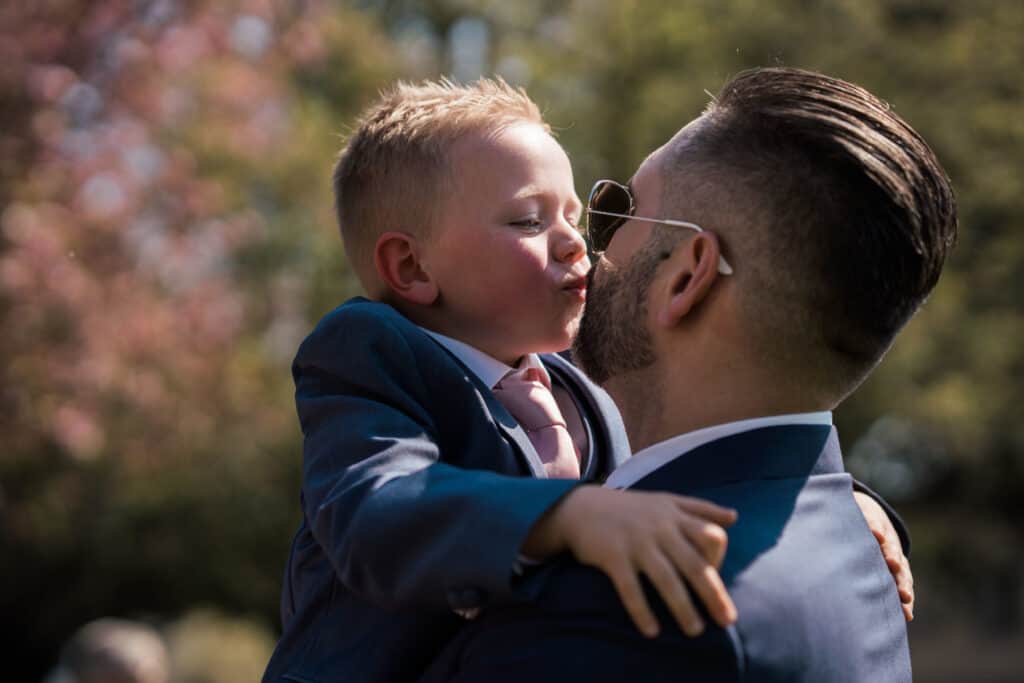 Groom lifting page boy up