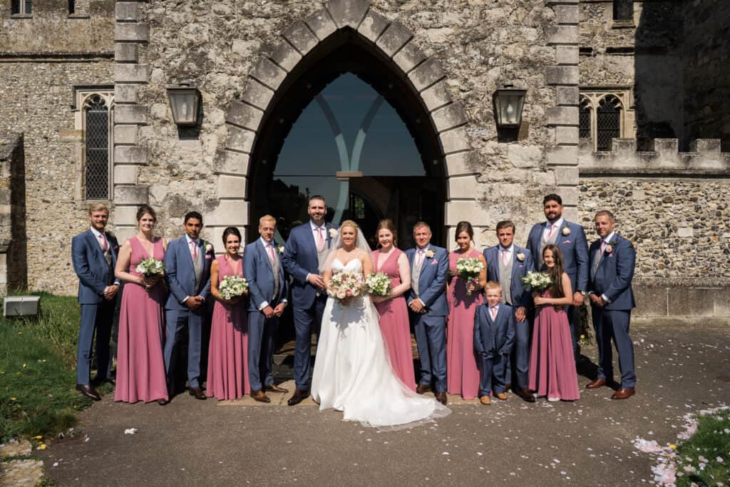 Church group shot of bride, groom , bridesmaids and groomsmen