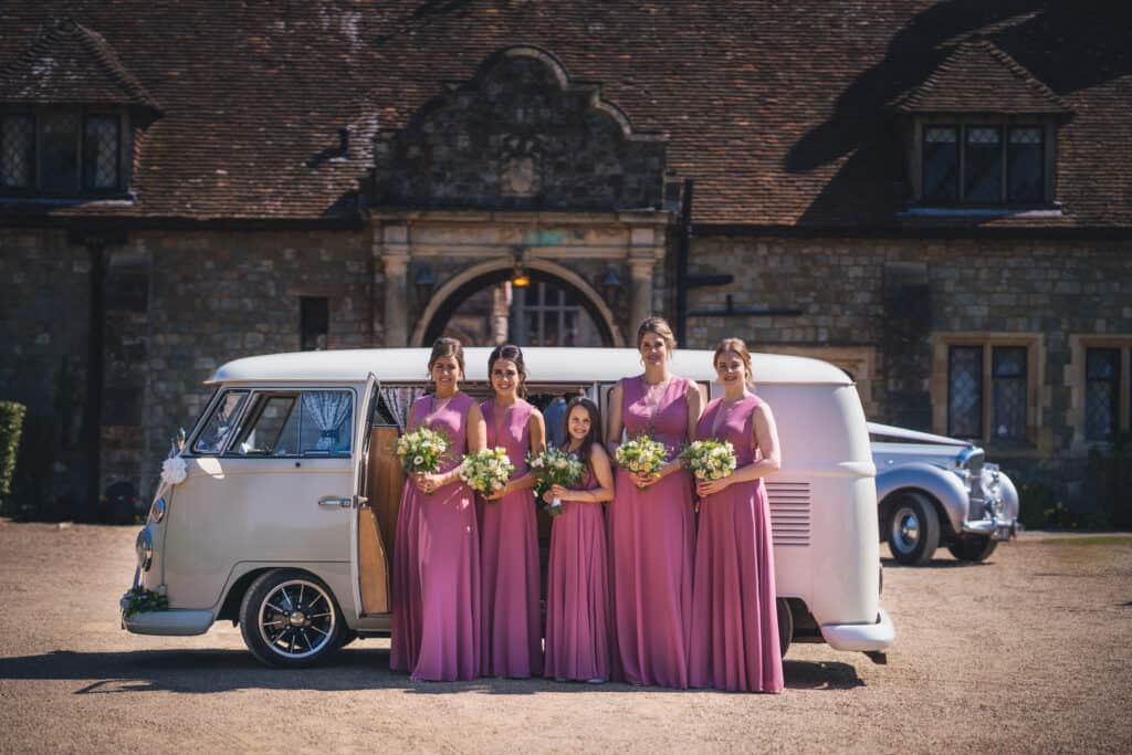 Bridesmaids in front wedding VW campervan at Eastwell Manor wedding