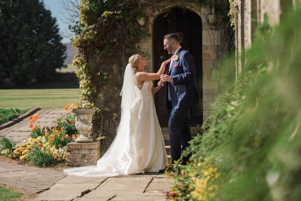 Eastwell Manor Wedding photos bride and groom  photos in the grounds