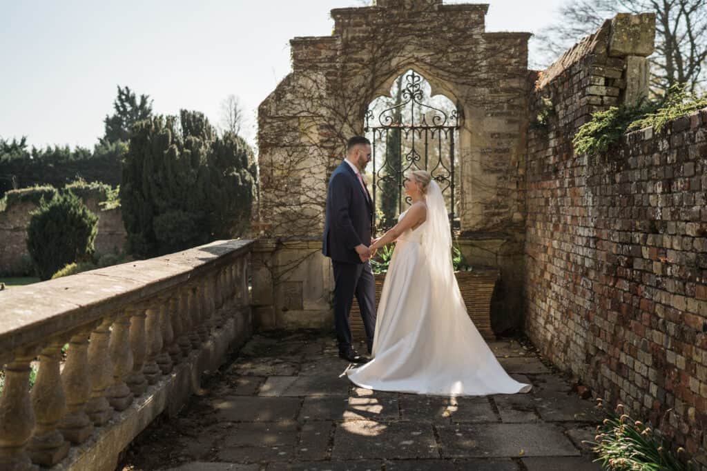 Eastwell Manor Wedding photos bride and groom  photos in the grounds