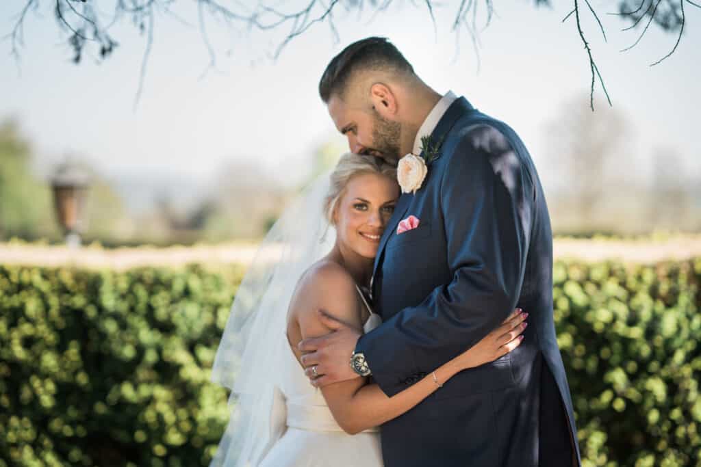 Eastwell Manor Wedding photos bride and groom  photograph in the grounds