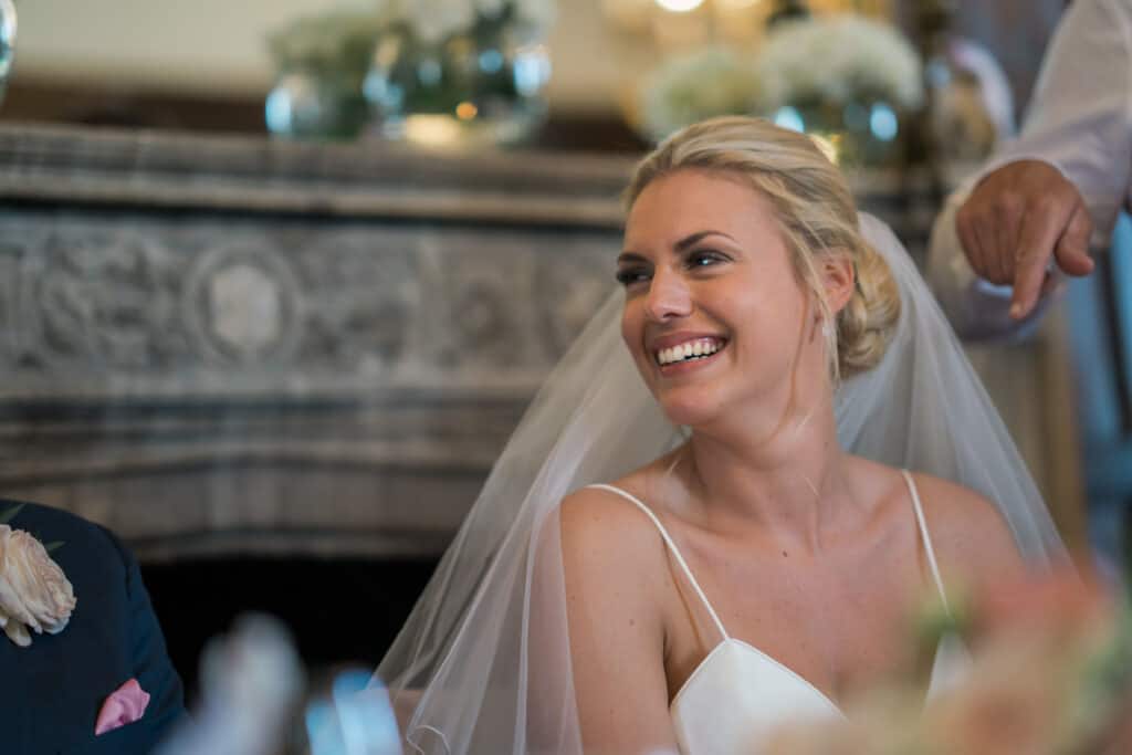 Bride smiling at wedding breakfast