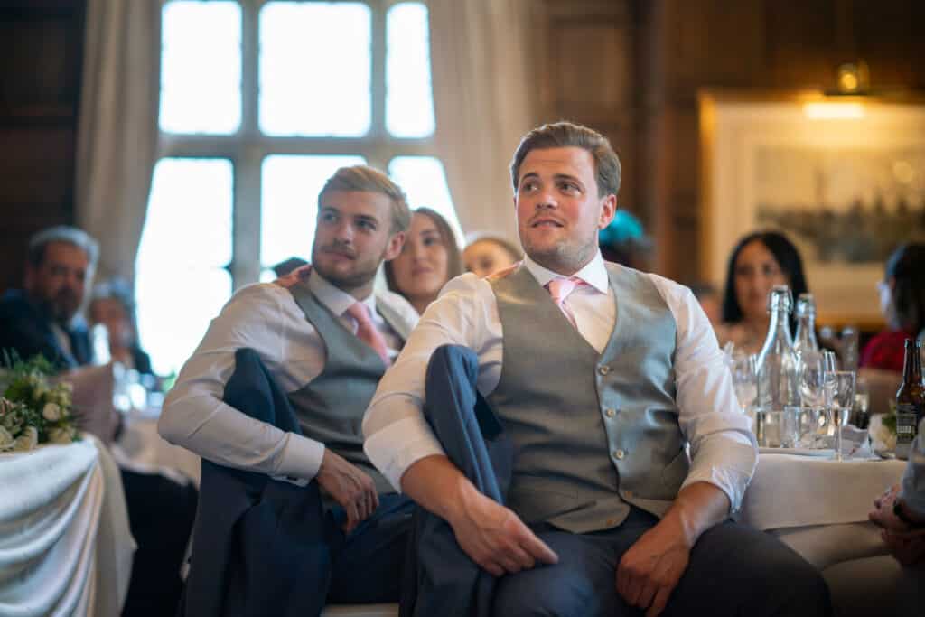 Groomsman listening to wedding speech