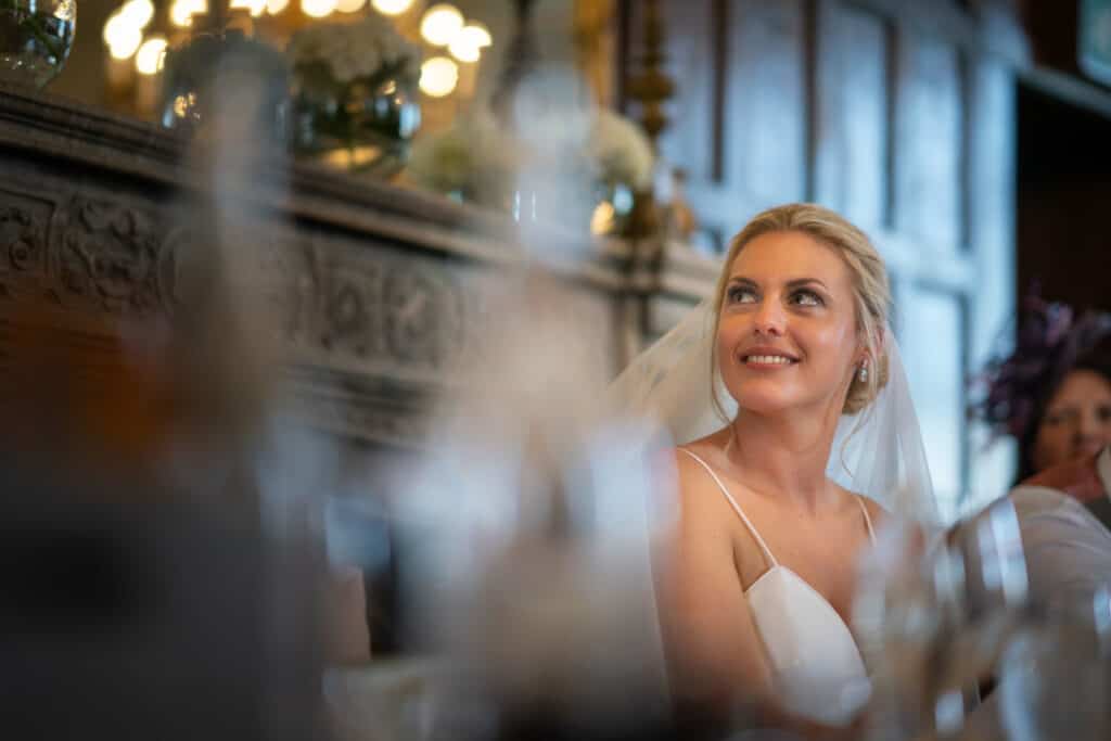 Bride smiling at wedding speech