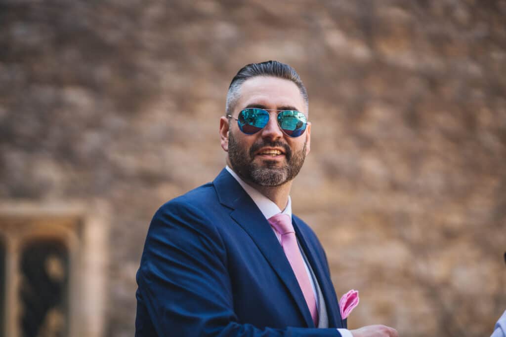 Groom in sunglasses before wedding