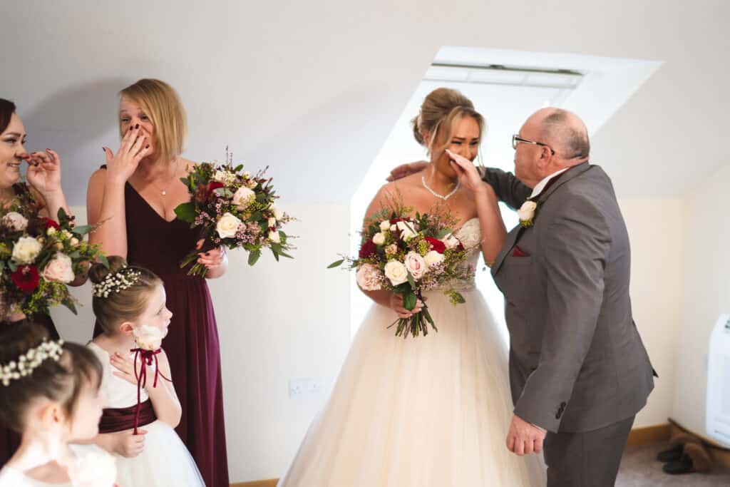 Father of the bride first sees bride photograph