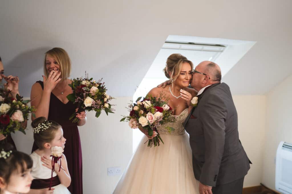 Father of the bride first sees bride photograph