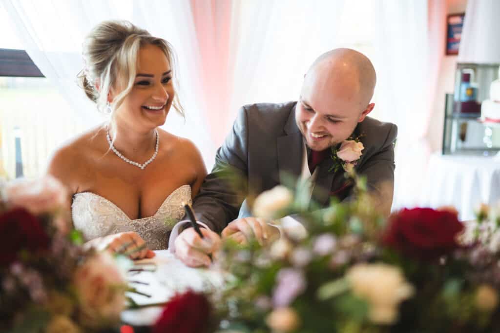 Bride and groom signing register at Weald of Kent Wedding