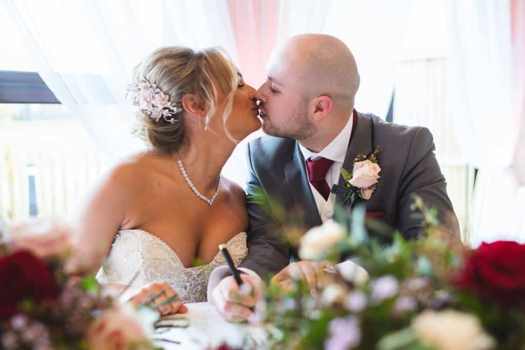 Bride and groom signing register at Weald of Kent Wedding