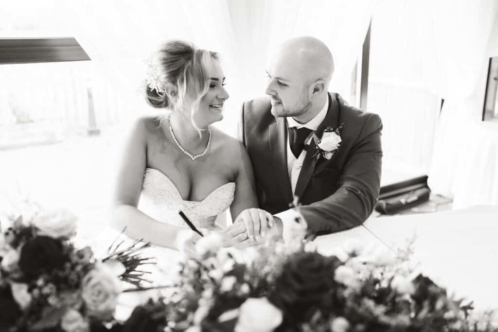 Bride and groom signing register at Weald of Kent Wedding