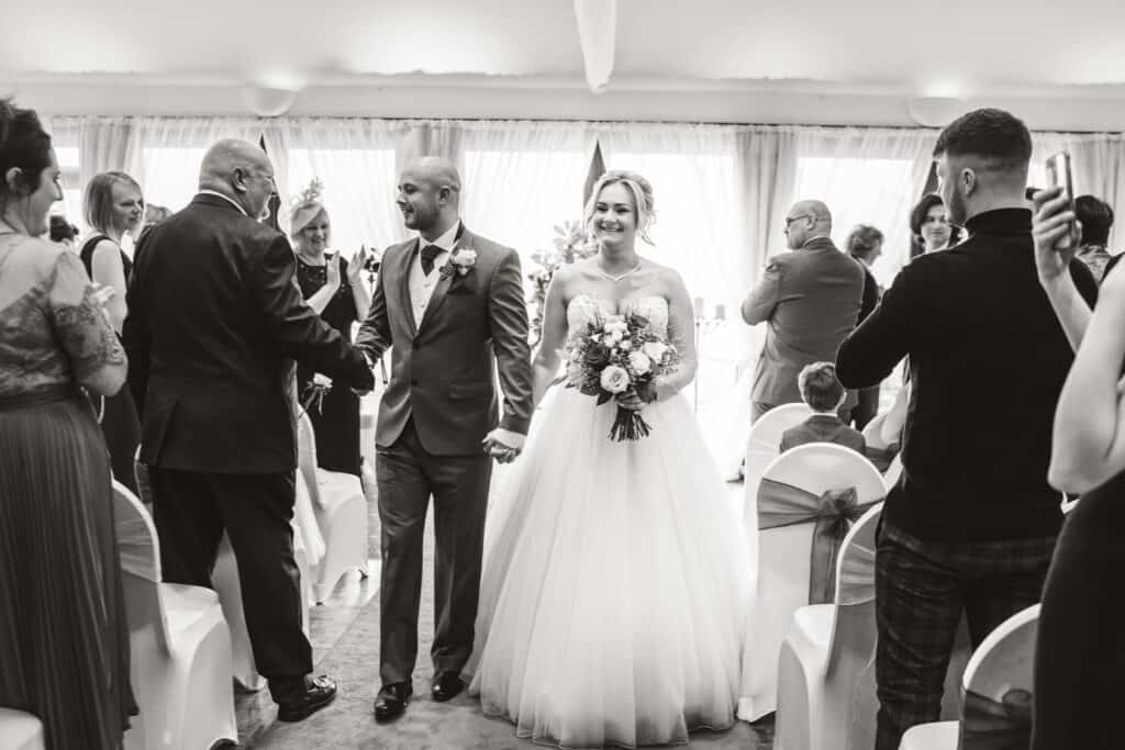 Bride and groom down the aisle potograph at Weald of Kent Wedding