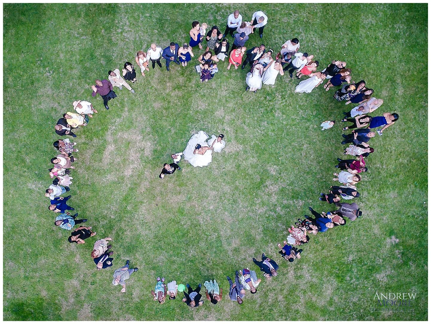 drone aerial photograph of wedding people in circle couple in middle 