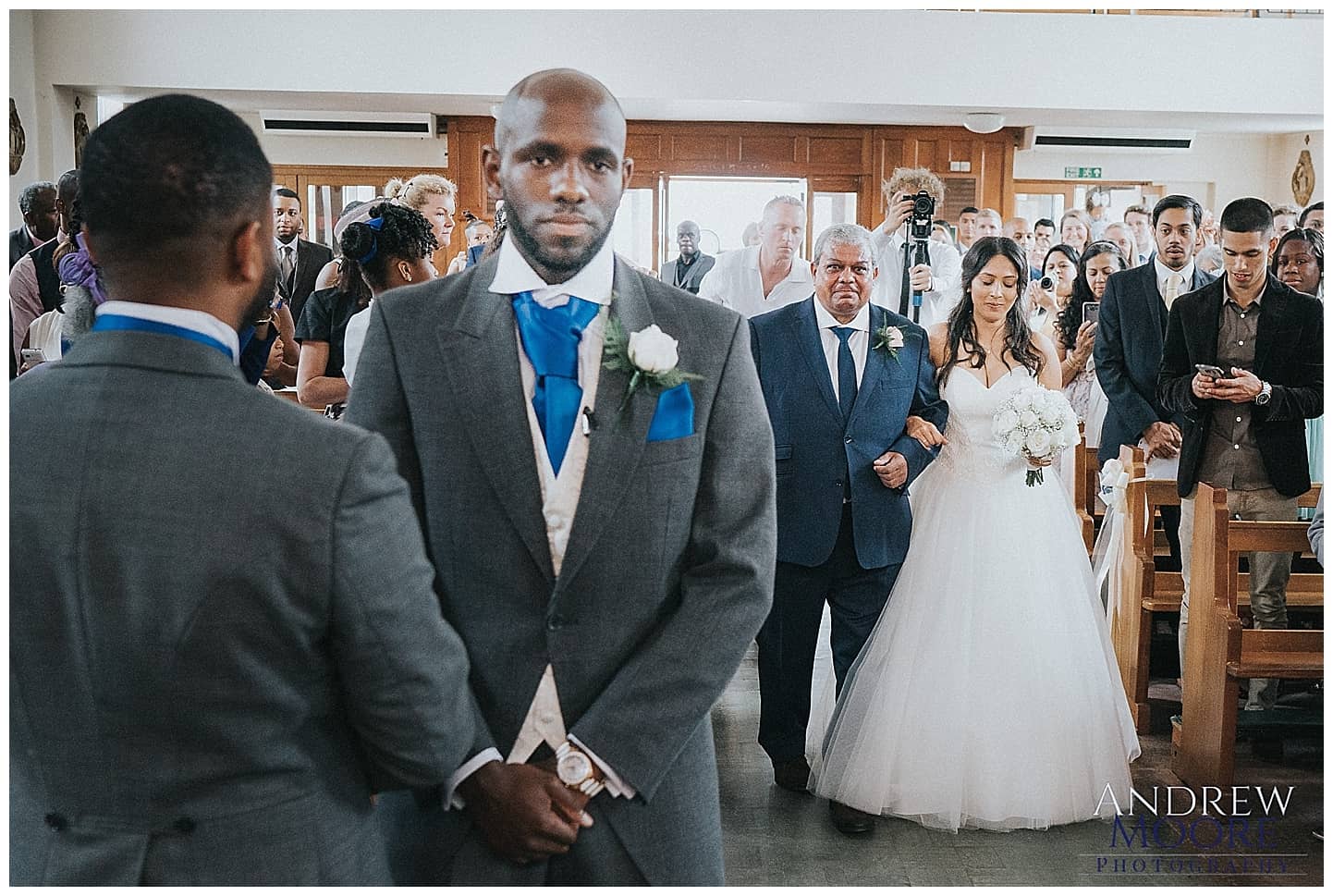 wedding, Groom nervous waiting for bride as she comes down aisle 