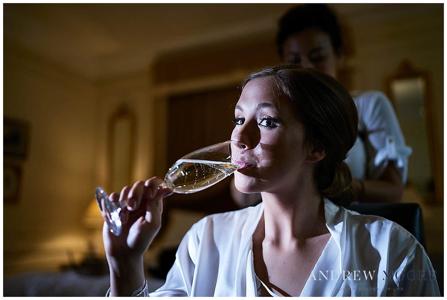 bride sipping bubbly while getting ready for wedding day at four seasons hotel 