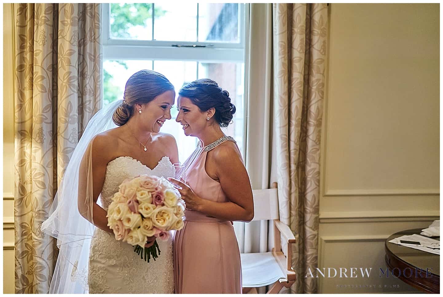 bride and bridesmaid having fun before wedding 