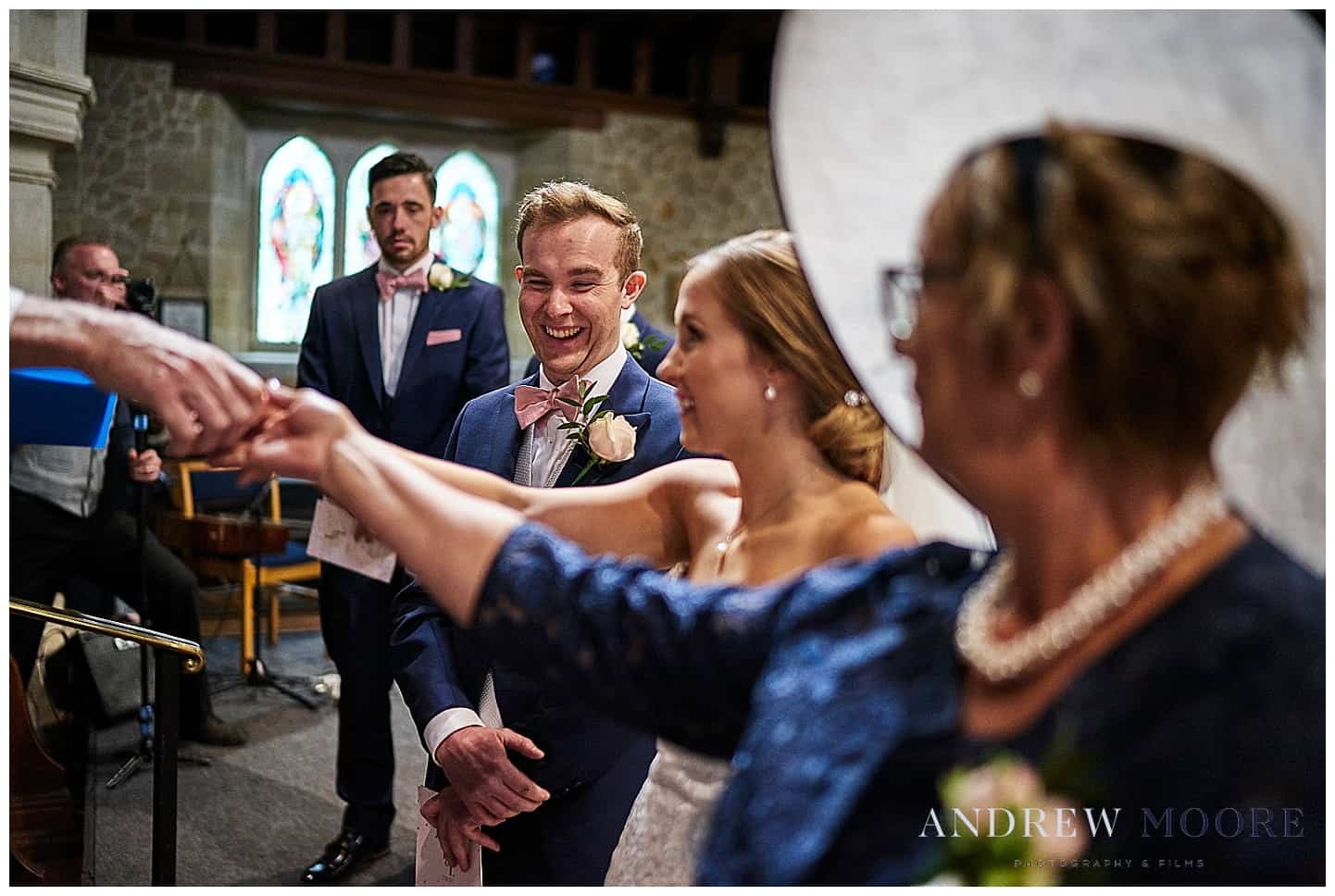 laughing groom at wedding cain manor wedding surrey grayshot church