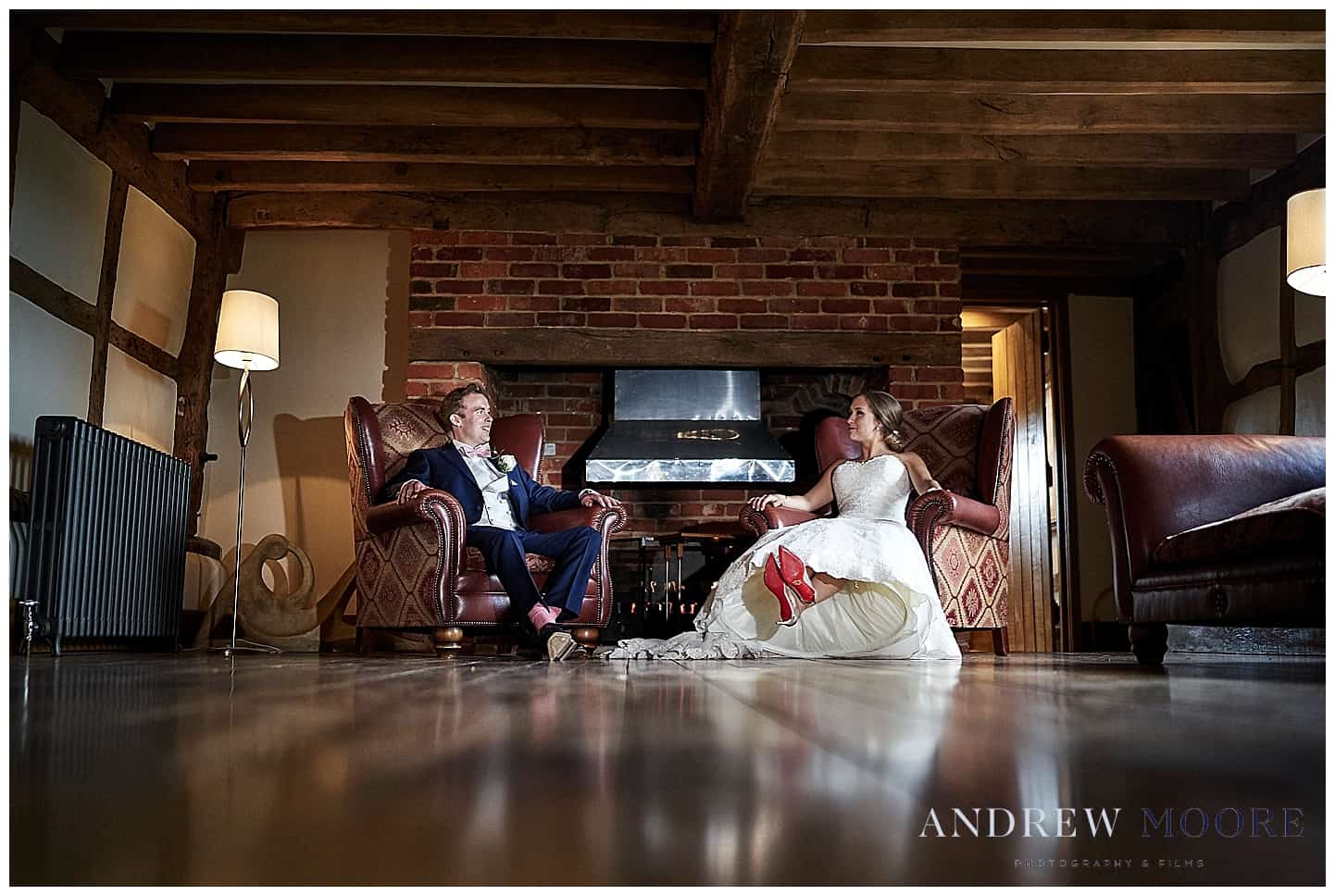 bride and groom on shiny wooden floor red shoes cain manor 