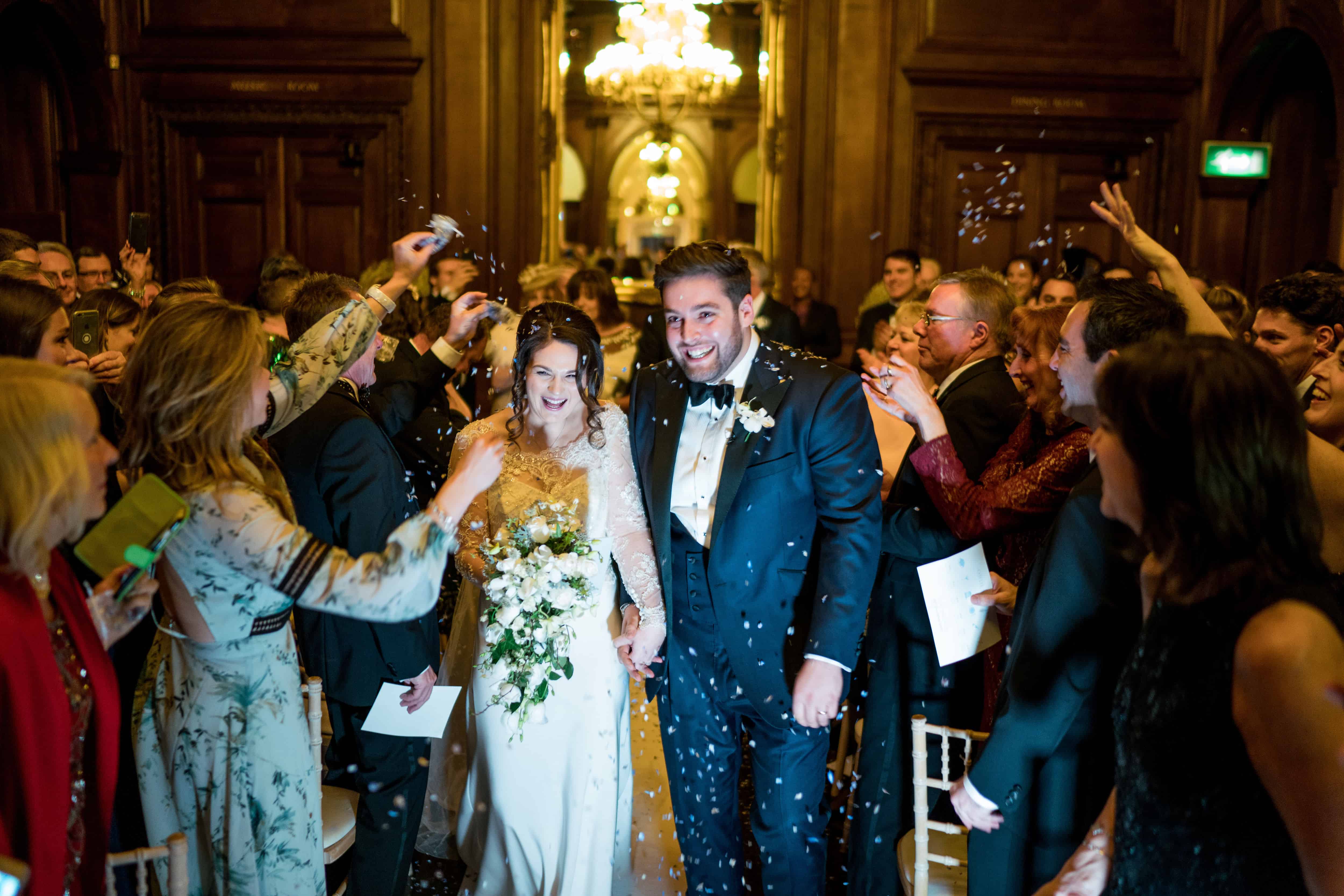 Wedding couple waking down aisle confetti